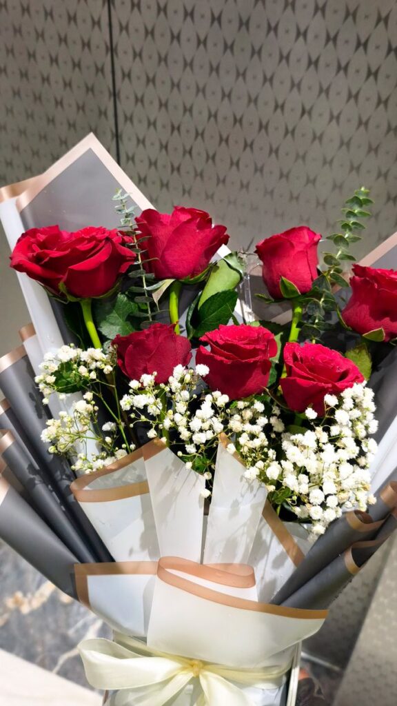 A beautiful bouquet of red roses and baby's breath, perfect for romantic occasions.